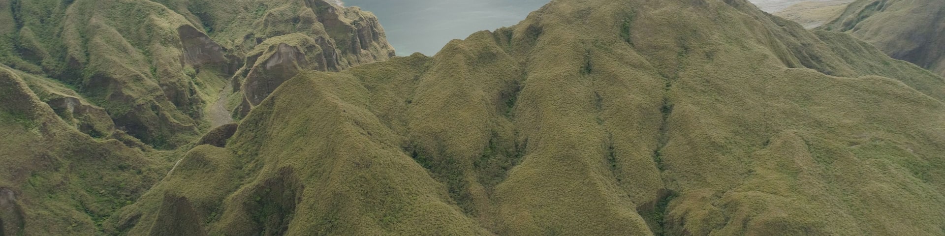 A mountainous landscape with a lake surrounded by rugged terrain.