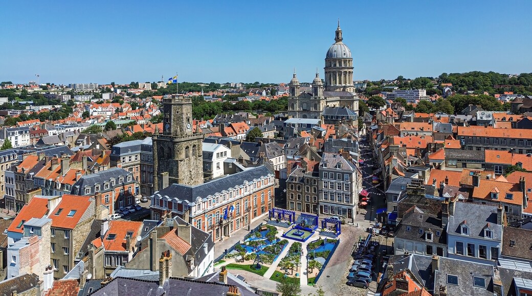 A historic town with a prominent church, a tower, and a well-maintained public square.