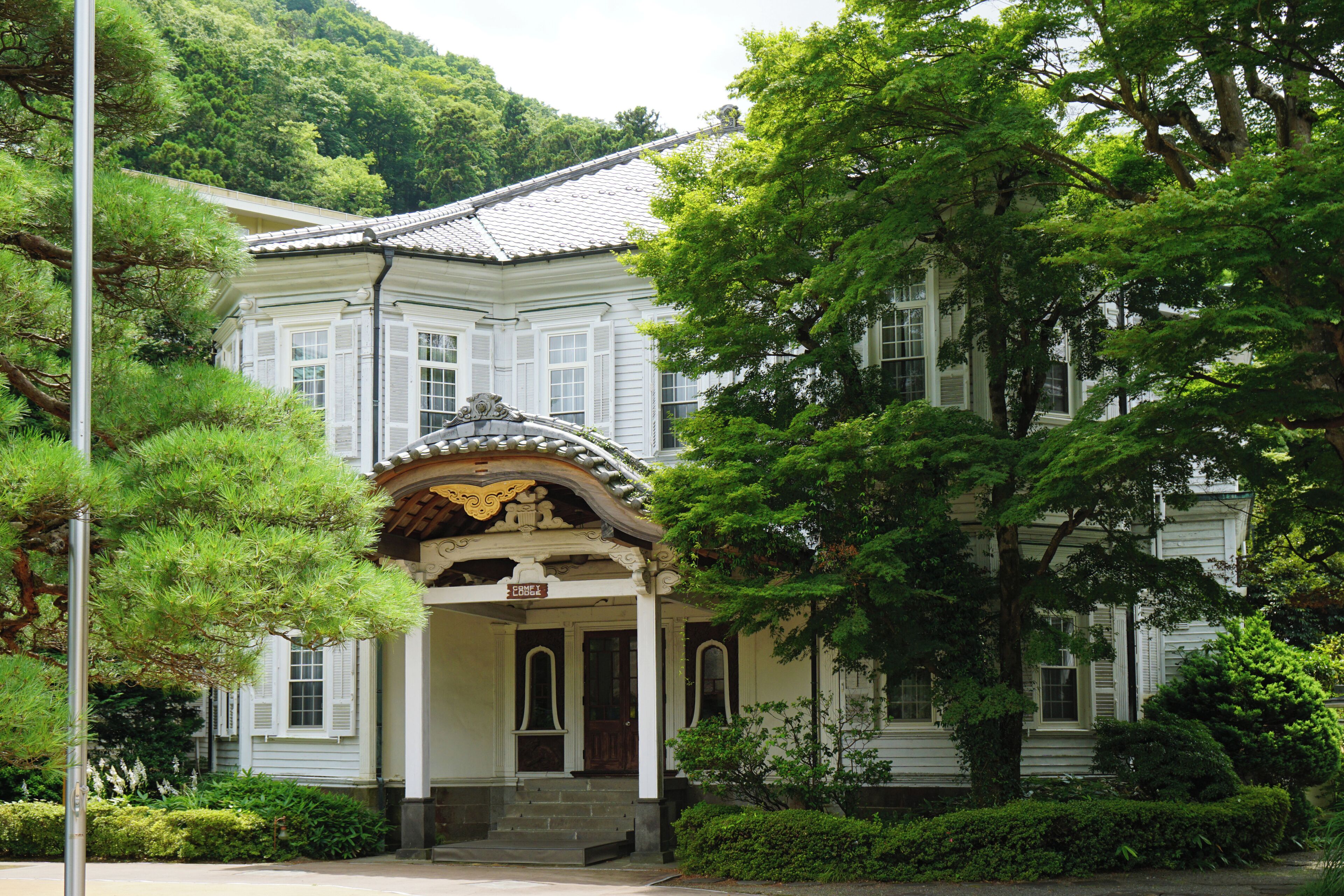 A traditional Japanese building with a tiled roof and ornate entrance.