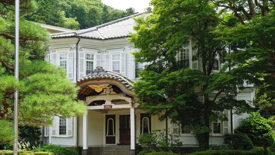 A traditional Japanese building with a tiled roof and ornate entrance.