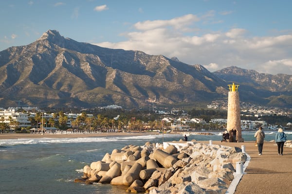 Puerto Banus Beach which includes a lighthouse, mountains and general coastal views