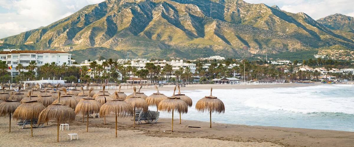 Puerto Banus Beach featuring a beach, a coastal town and mountains