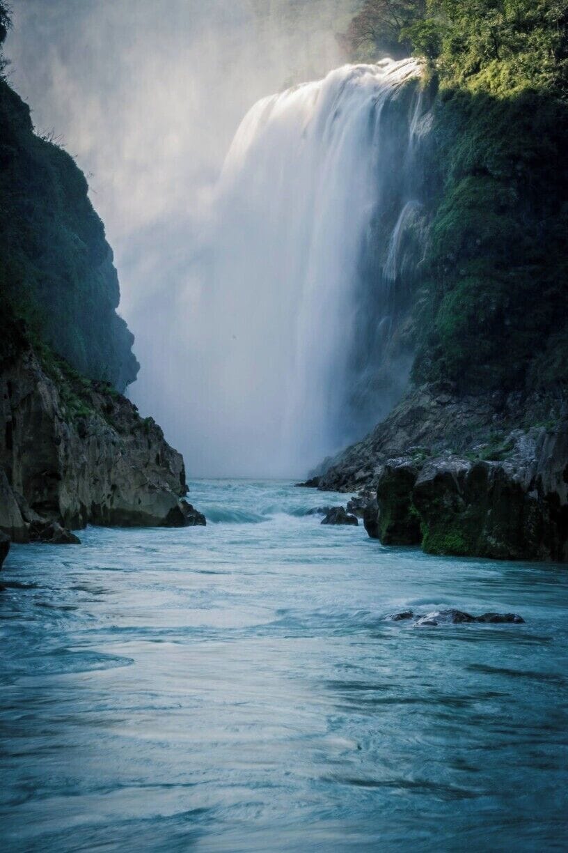Standing on a small rock in the middle of the river, I lowered my camera as near to the water as possible in order to take this picture of the Tamul's waterfall