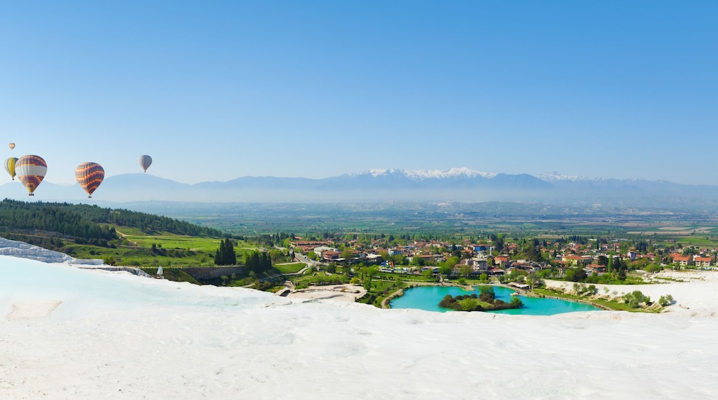 Panoramic collage with hot air ballons flying above snowy white Pamukkale in Turkey