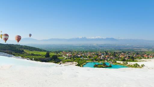 Panoramic collage with hot air ballons flying above snowy white Pamukkale in Turkey