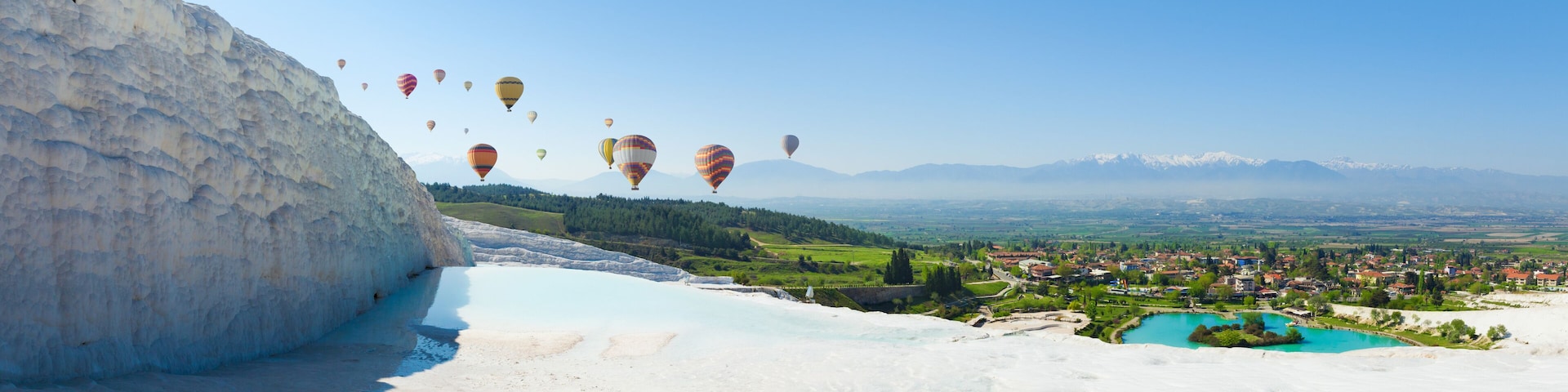 Panoramic collage with hot air ballons flying above snowy white Pamukkale in Turkey