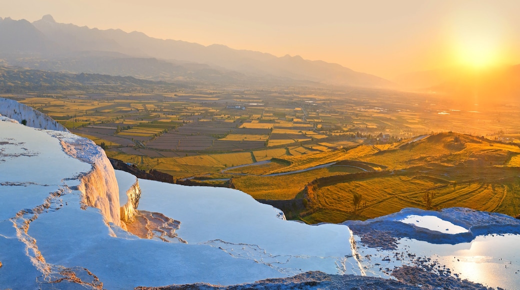 Panorama terraces from travertine in Pamukkale at sunset.