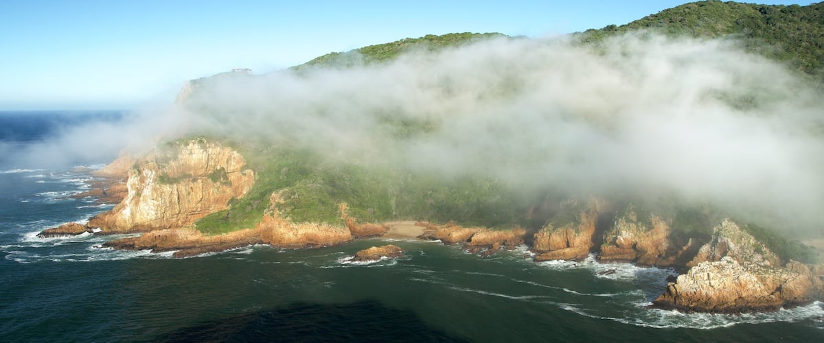 Knysna showing rugged coastline, landscape views and mist or fog