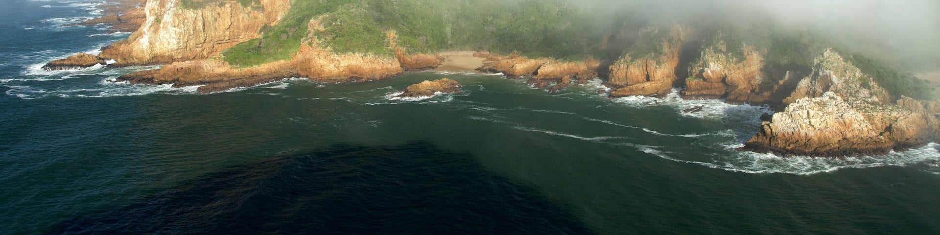 Knysna showing rugged coastline, landscape views and mist or fog