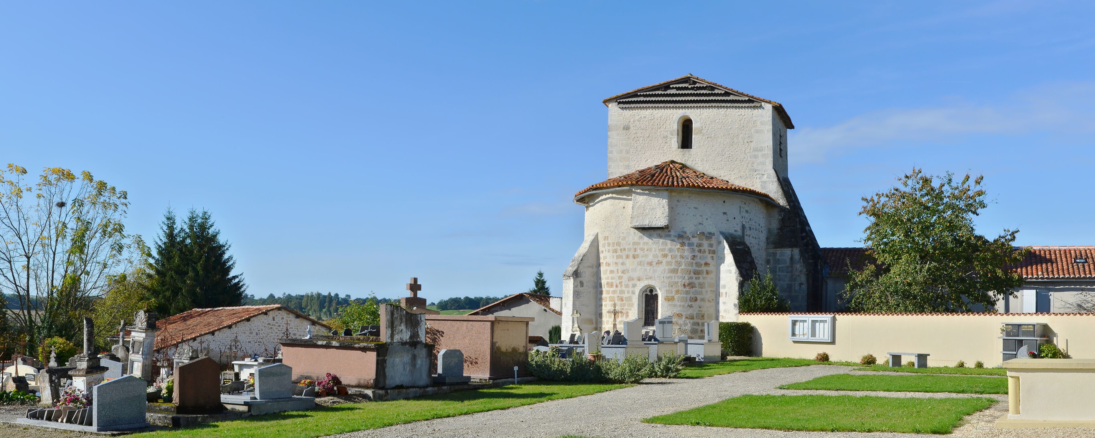 Church (12th, 15th and 16th centuries) and new part of the cemetery (ENE view), Courgeac, Charente, France.