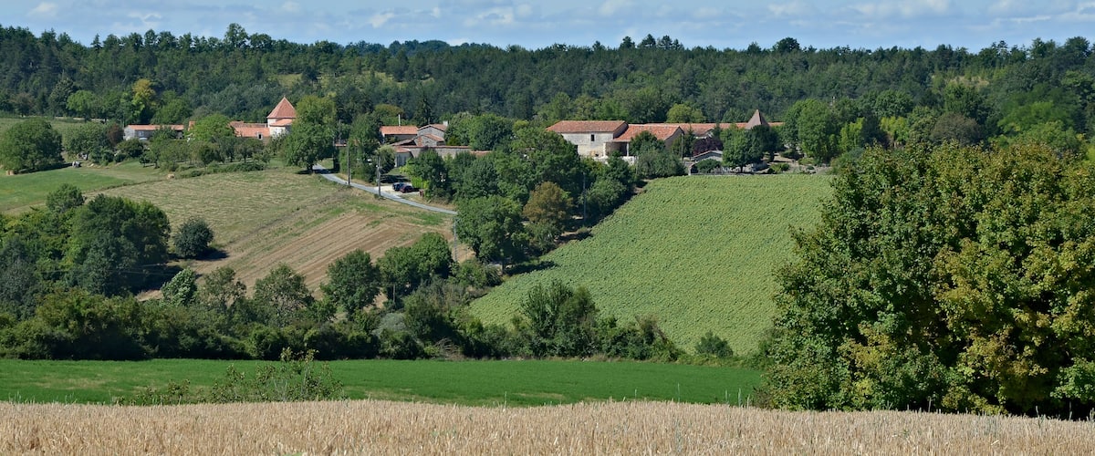 Country landscape with a farmstead, as seen from road D 143, Vaux-Lavalette, Charente, France.