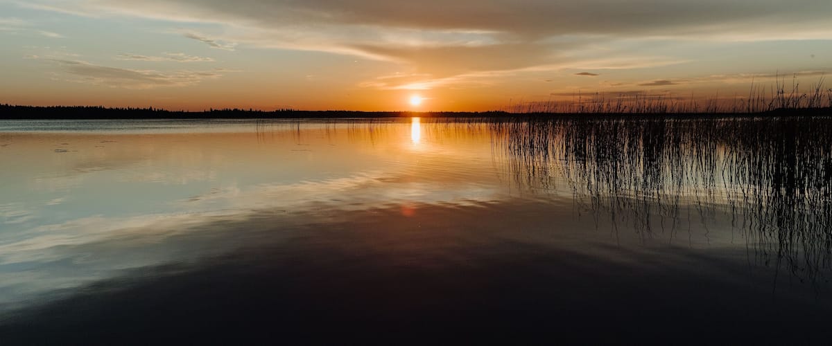 A sunset reflecting on the horizon in Candle Lake, Northern Saskatchewan, Canada