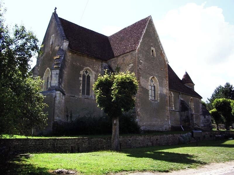 A historic church with a steeply pitched roof and arched windows.