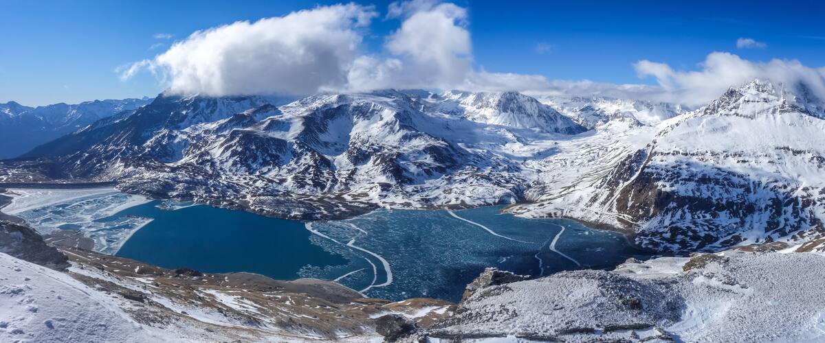 A snow-covered mountain range with a glacial lake.