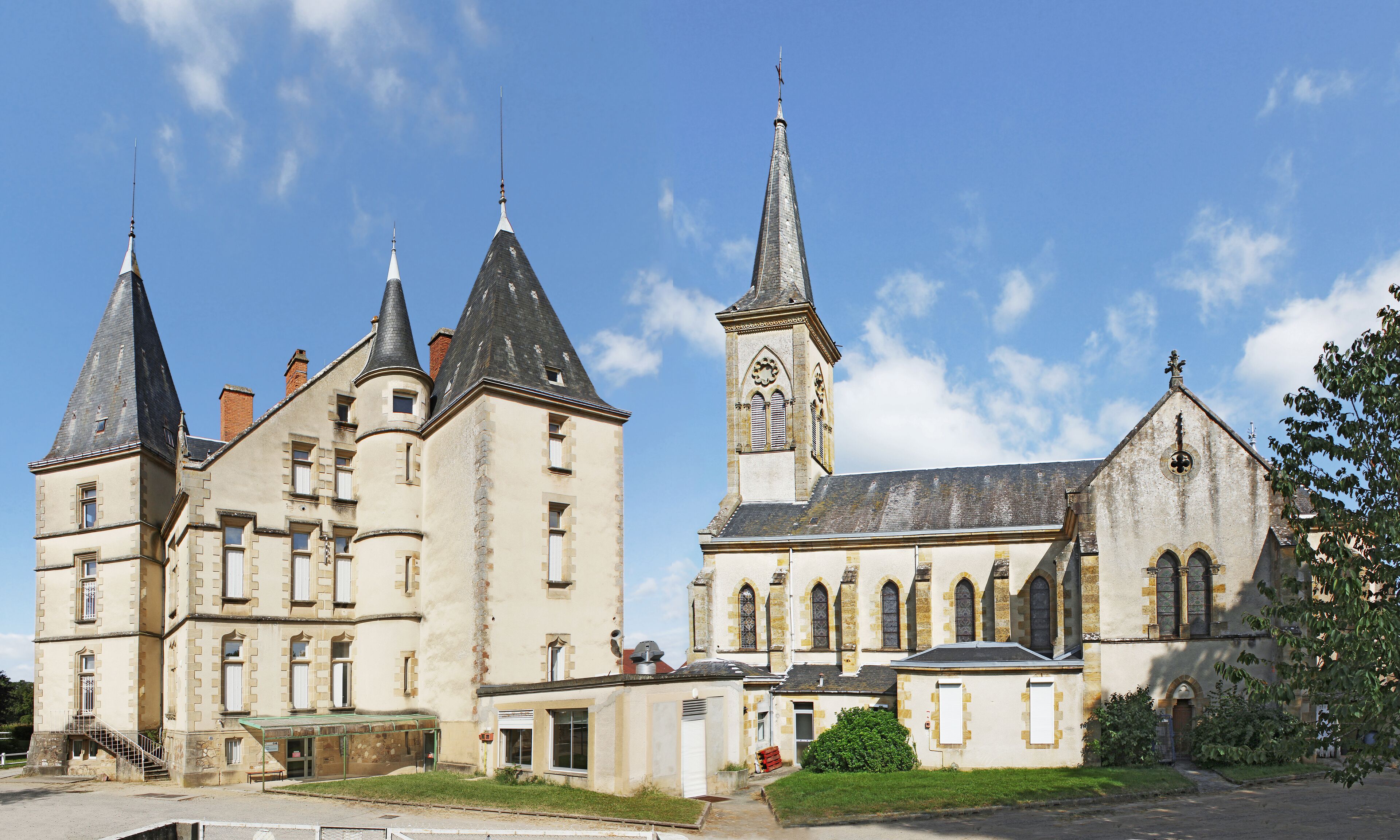 A historic building with multiple spires and a clock tower.