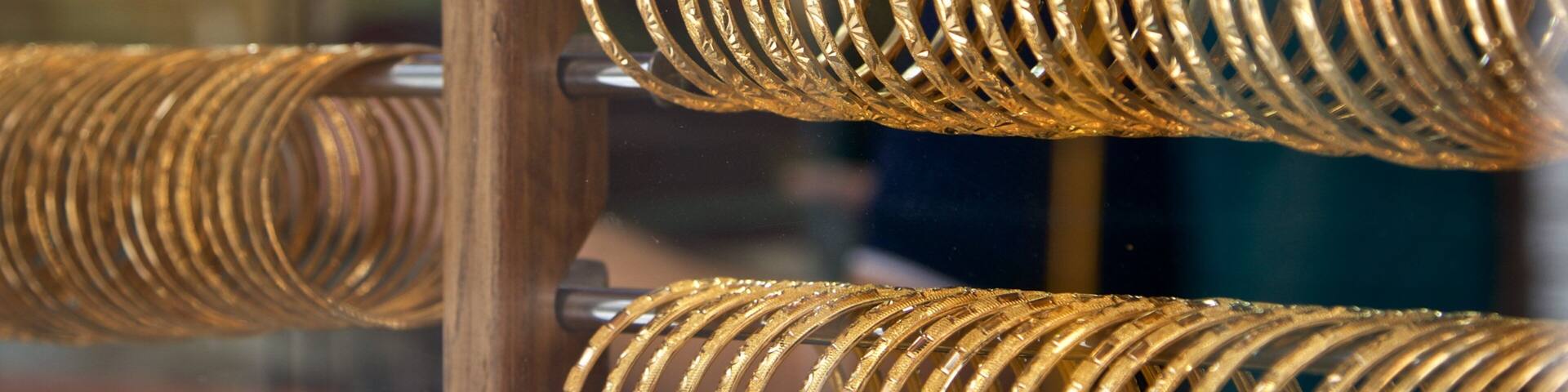 A display of intricately designed gold bangles.