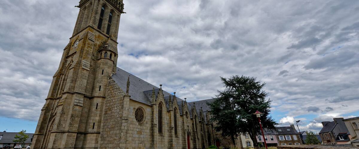 A historic church with a tall spire and arched windows.