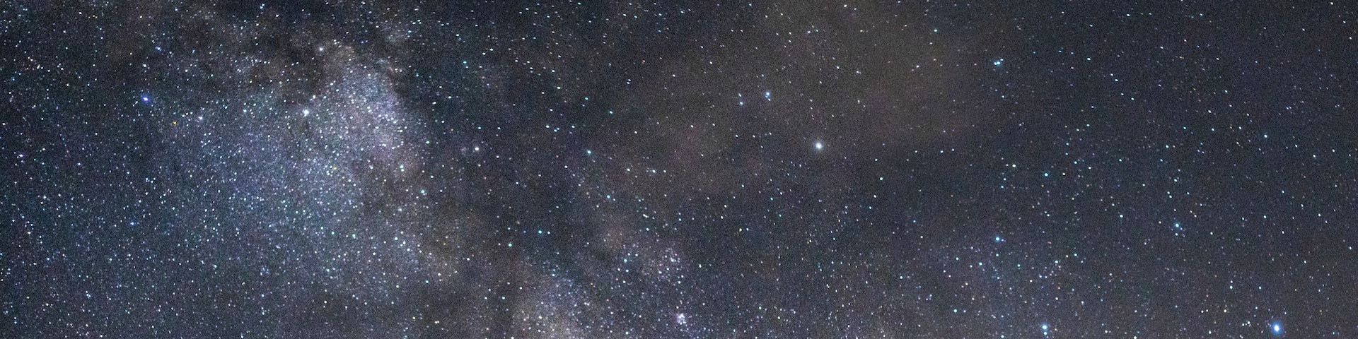 A metal tower with a platform and stairs, surrounded by a starry night sky.