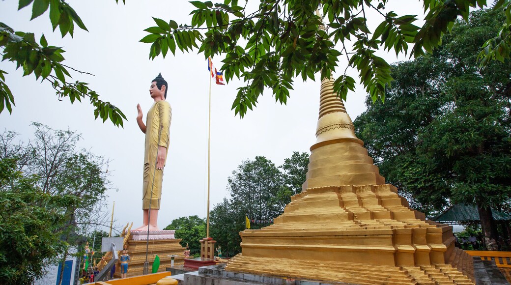 Ancient golden pagoda and buddha statue at Wat Phnom Yat.