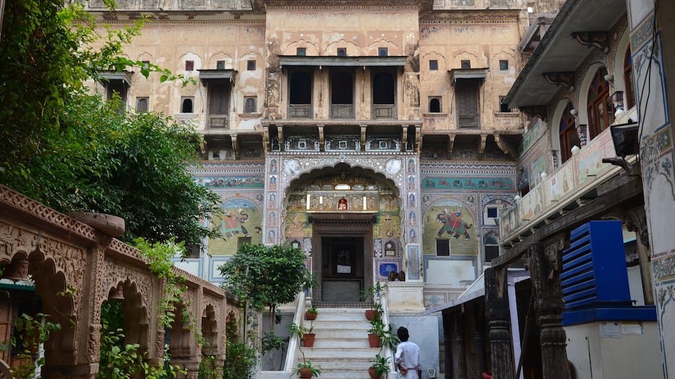 A historic building with intricate carvings and a grand entrance.