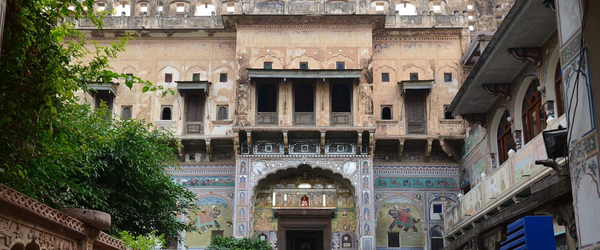 A historic building with intricate carvings and a grand entrance.