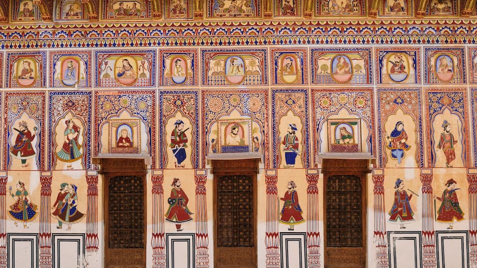 A richly decorated wall with intricate patterns and figures.