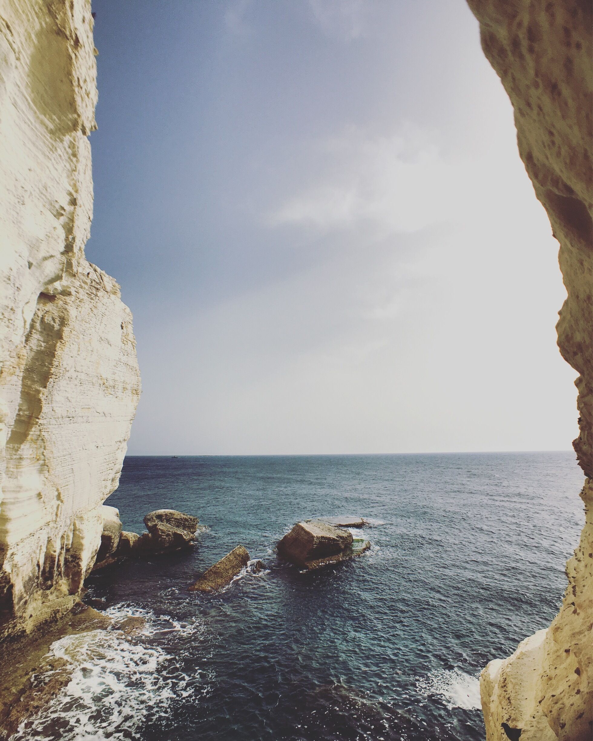 A coastal scene with white cliffs and the ocean.
