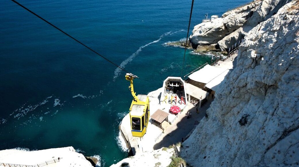 At Israel's northwestern tip, at the only point where the sea meets the cliffs, is where you will find the enchanting tourist site of Rosh Hanikra. The cable car, which is the steepest in the world, takes visitors down for a fascinating encounter with the sea grottoes.