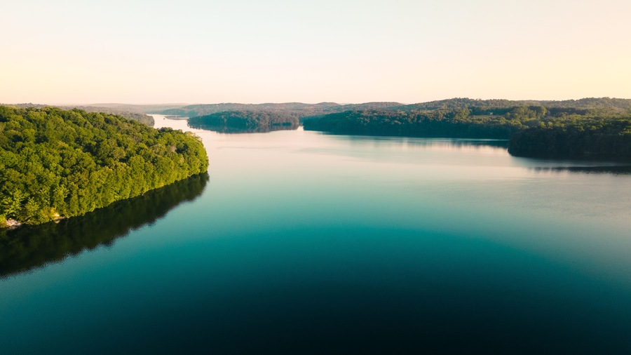 Aerial Photo of a large river surrounded by lush forests in New York.