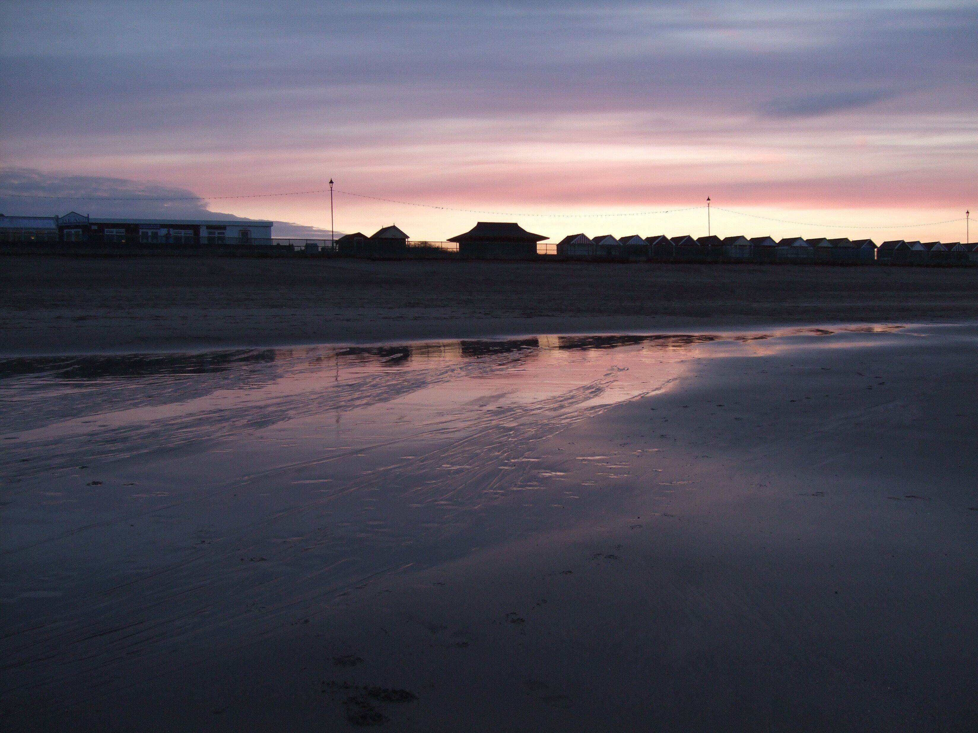 Beach huts at Sutton on Sea. Taken in silhouette against a setting spring sun.1804164