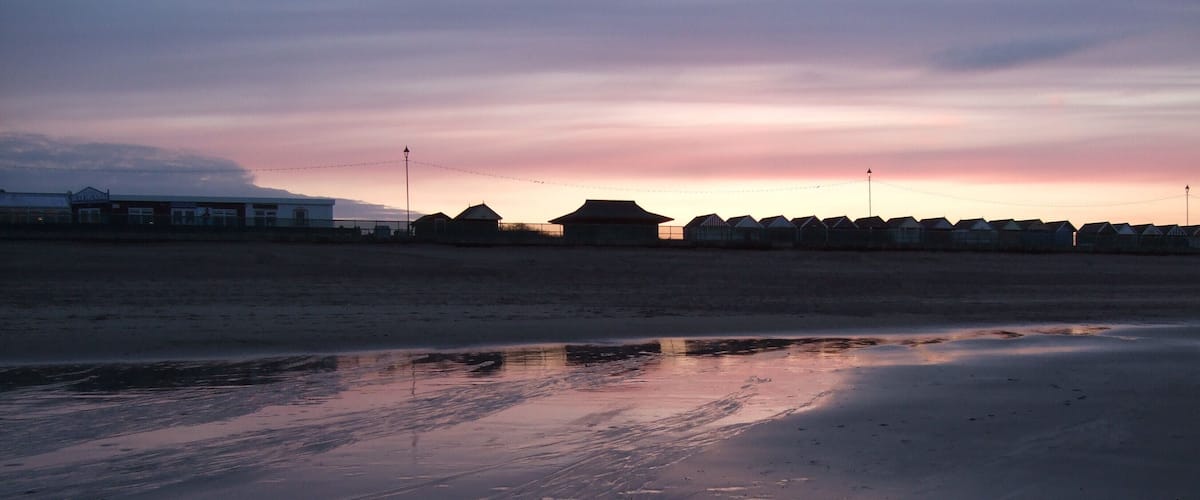 Beach huts at Sutton on Sea. Taken in silhouette against a setting spring sun.1804164