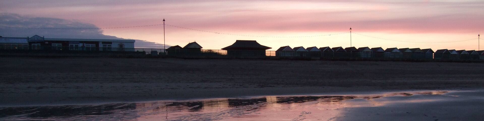 Beach huts at Sutton on Sea. Taken in silhouette against a setting spring sun.1804164