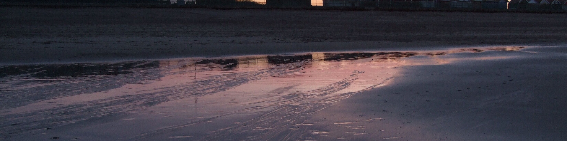 Beach huts at Sutton on Sea. Taken in silhouette against a setting spring sun.1804164