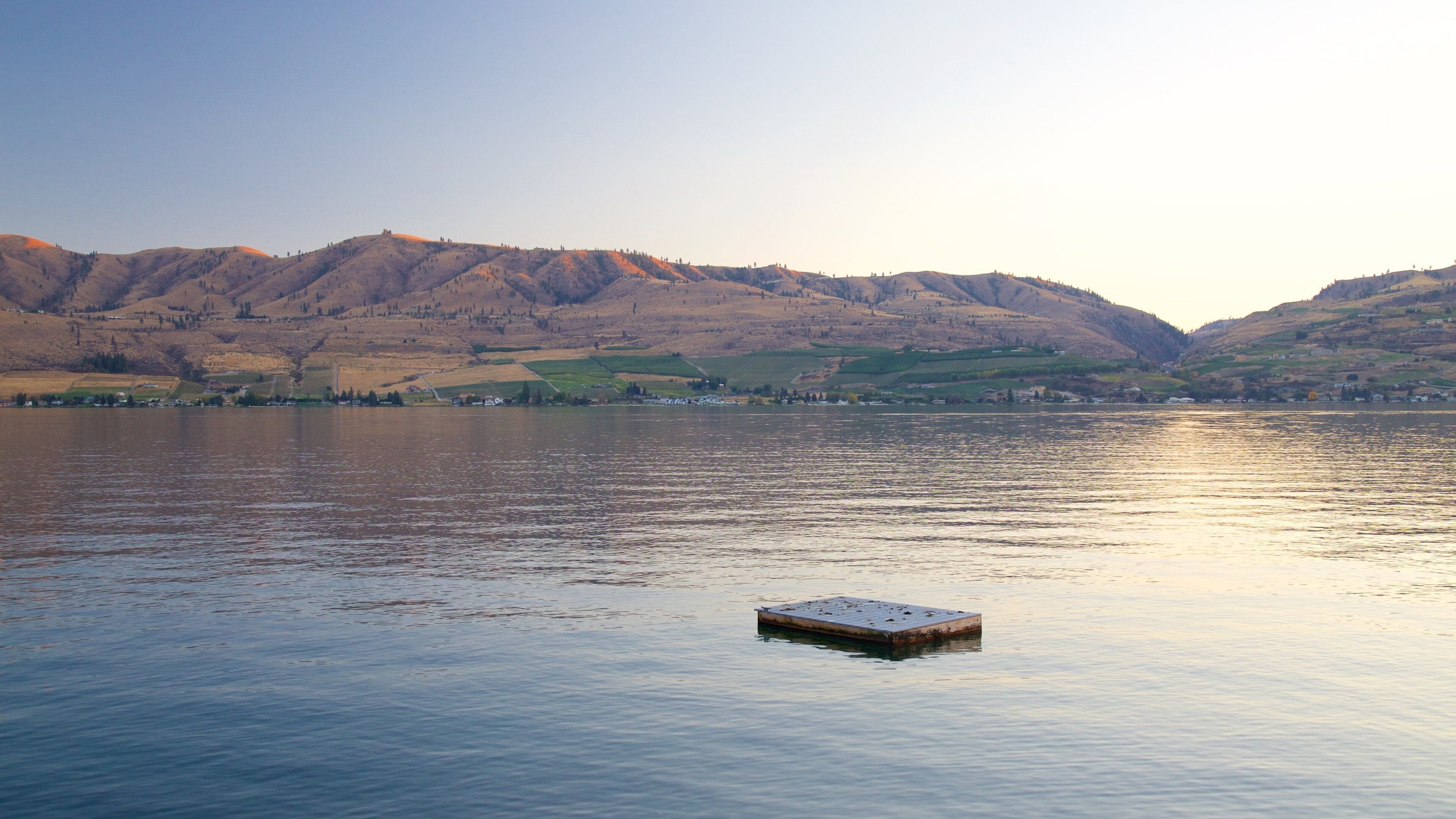 Lake Chelan which includes tranquil scenes, a lake or waterhole and a sunset