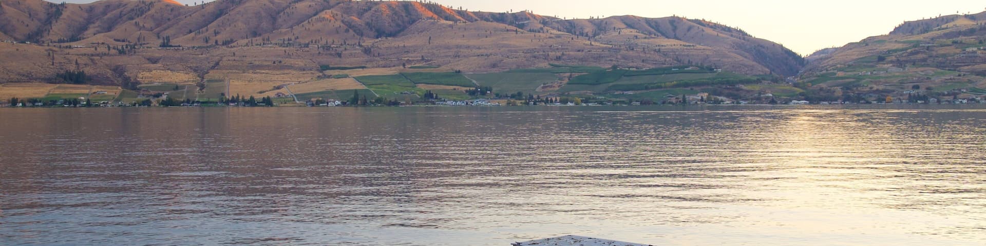 Lake Chelan featuring a lake or waterhole, a sunset and tranquil scenes