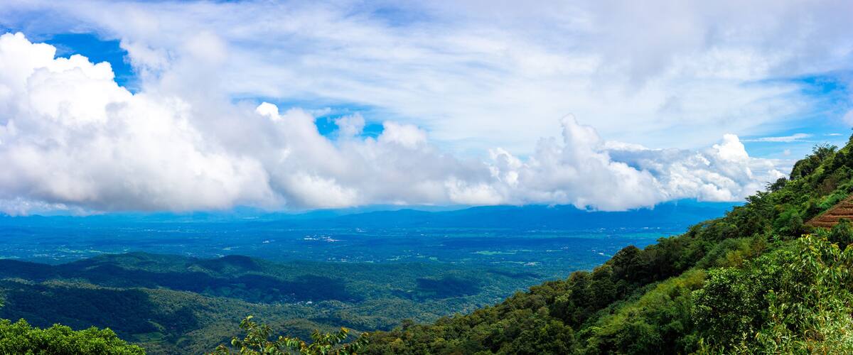 View of high hills and big clouds in the blue sky on Doi Mon Chaem, Chiang Mai, Thailand.