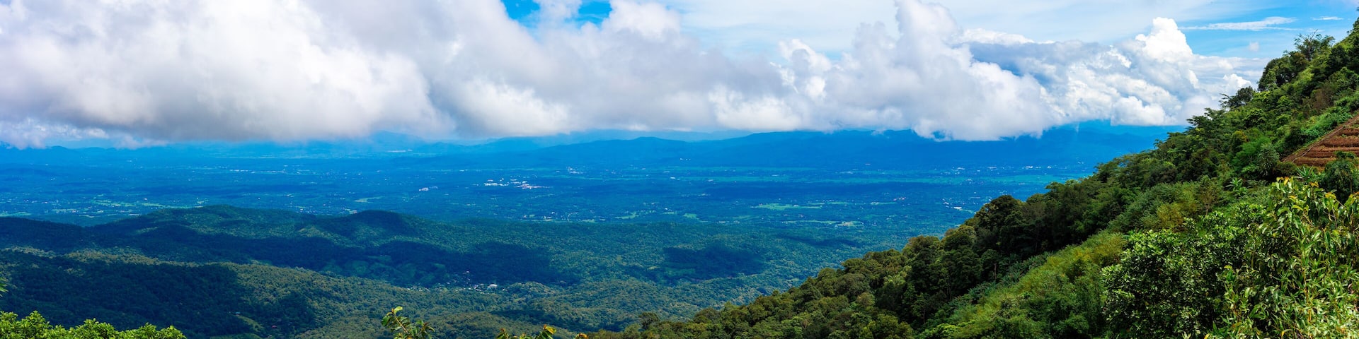 View of high hills and big clouds in the blue sky on Doi Mon Chaem, Chiang Mai, Thailand.