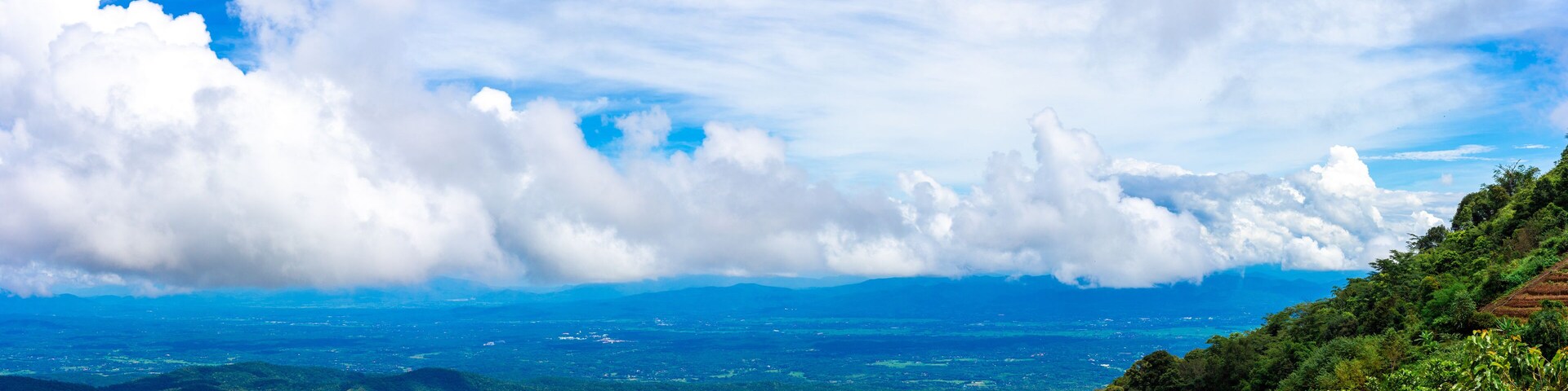 View of high hills and big clouds in the blue sky on Doi Mon Chaem, Chiang Mai, Thailand.