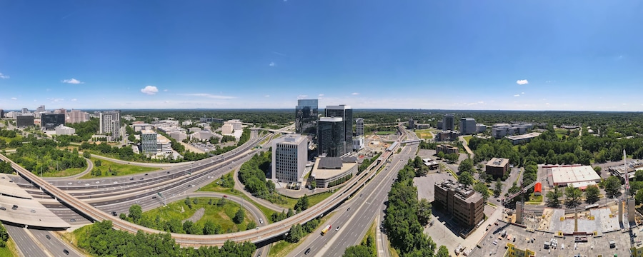 Aerial view of road interchanges, subway line, highways and skyscrapers in downtown Tyson's Corner, Virginia.
