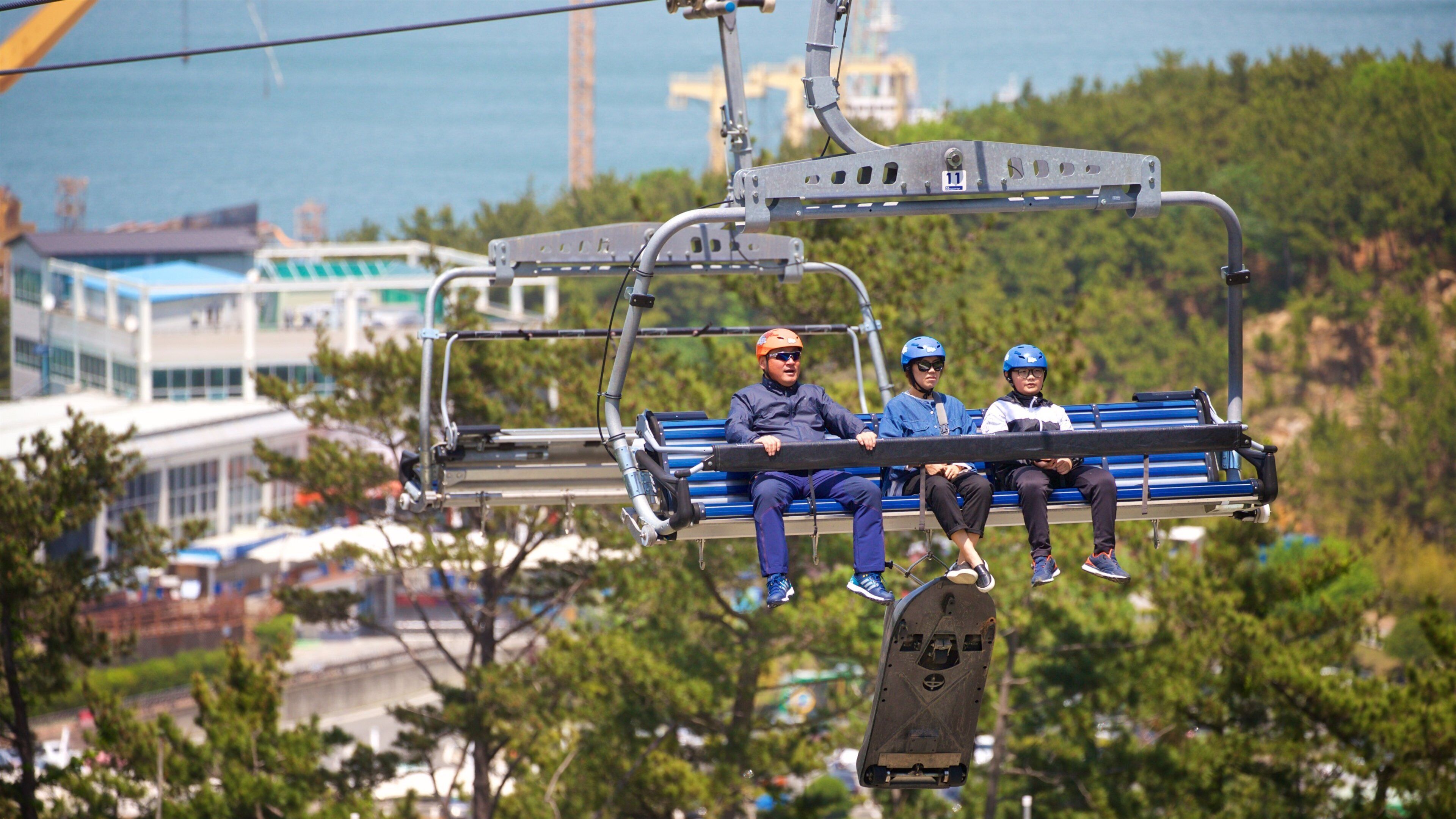 Skyline Luge Tongyeong featuring a gondola as well as a family