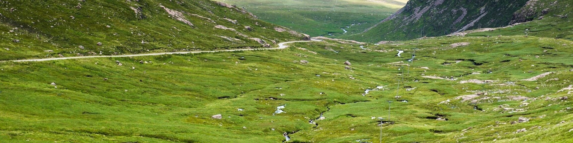The Bealach na Ba ("Pass of the cattle") is not a single attraction, it doesn't have a visitor centre, and there are no visitor facilities as such.
But the Bealach is an unforgettable drive up and along one of the most dramatic roads on mainland UK, rivalling many a Swiss mountain pass and with terrific views across much of Wester Ross, the whole of Skye, and the Islands of Rum and the Outer Hebrides. You will NOT forget this drive as long as you live!