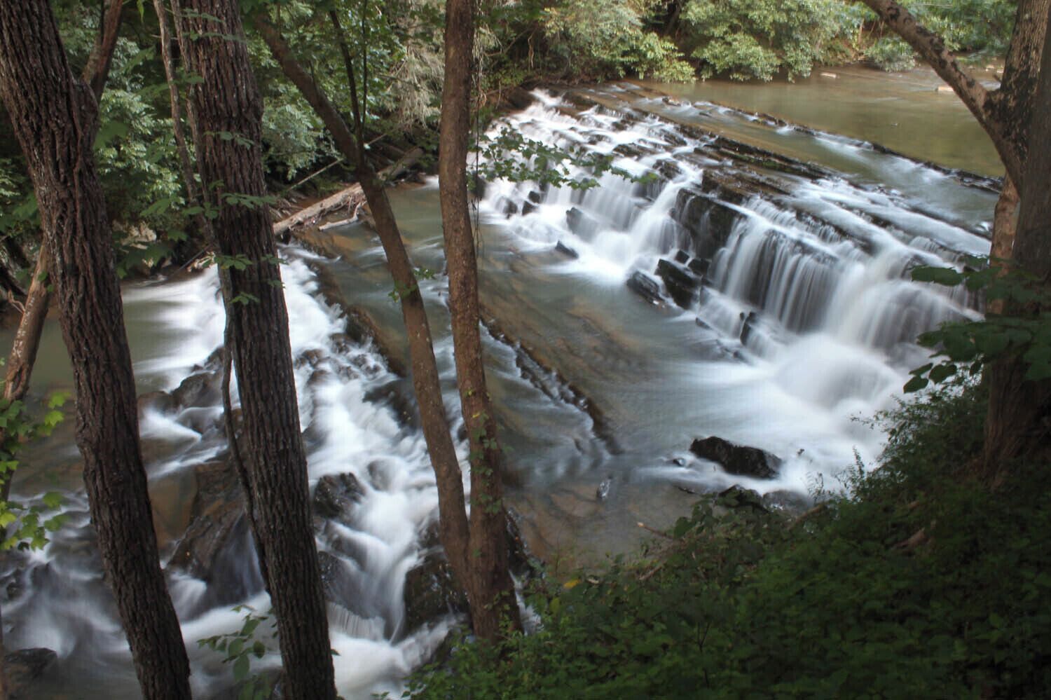 This pretty little waterfall is called Friendly Falls and is located in Wears Valley, Tennessee. Wears Valley is east of Pigeon Forge, much less busy and much more peaceful. The waterfall is located behind a restaurant that is perched on the side of Wears Valley Road, above the falls. #WearsValley #waterfall #mountains #Tennessee #FriendlyFalls