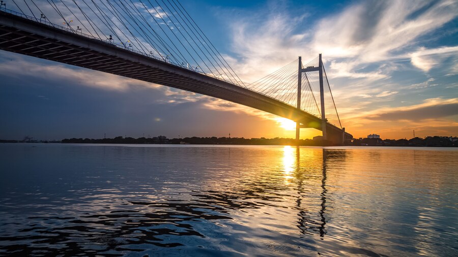 Vidyasagar Setu - the cable stayed bridge on river Hooghly at sunset with moody sky.
