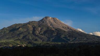 Panoramic view of the great Mount Merapi Volcano with clear blue sky in the background viewed from Selo Boyolali, Central Java - Indonesia.