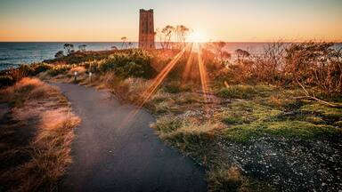 The view of the Boyd's Tower in Eden with the sunrise from the sea