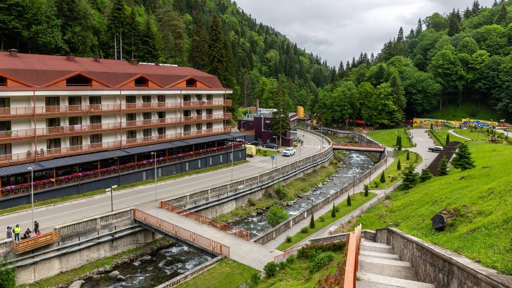 Health resort Sairme in Lesser Caucasus mounatins with natural thermal pools and mineral waters, landscape view with Bostania River and hotel on the hill, Georgia.