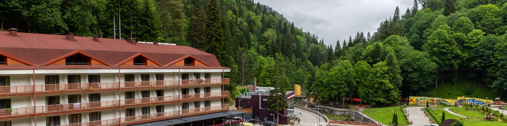 Health resort Sairme in Lesser Caucasus mounatins with natural thermal pools and mineral waters, landscape view with Bostania River and hotel on the hill, Georgia.
