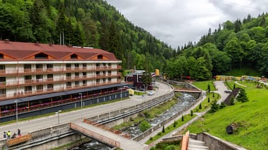Health resort Sairme in Lesser Caucasus mounatins with natural thermal pools and mineral waters, landscape view with Bostania River and hotel on the hill, Georgia.