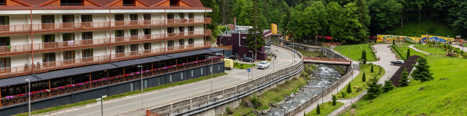 Health resort Sairme in Lesser Caucasus mounatins with natural thermal pools and mineral waters, landscape view with Bostania River and hotel on the hill, Georgia.
