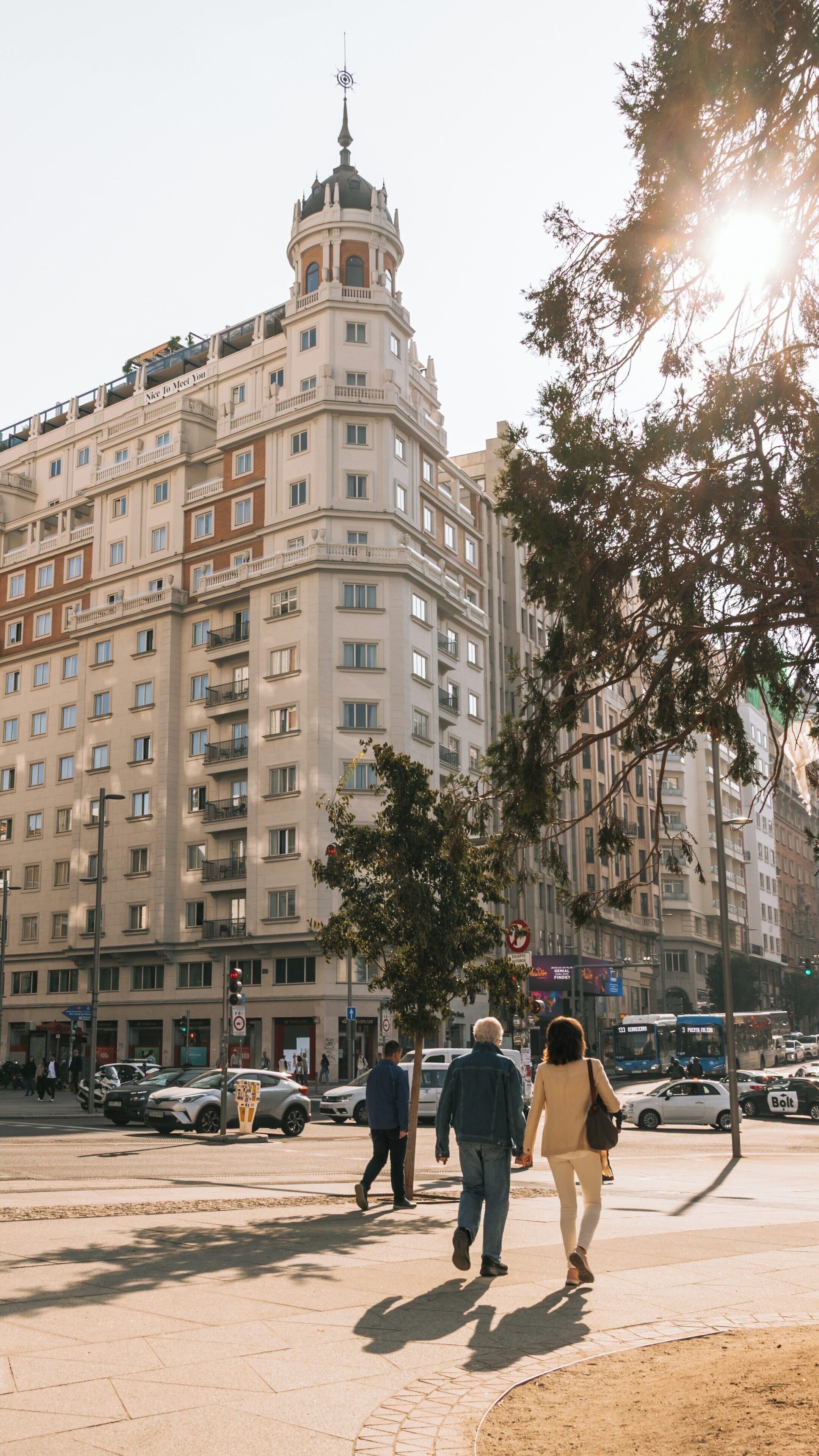 Exploring Plaza de Espana in Malasana, Madrid during a sunny day filled with vibrant city life and historical architecture